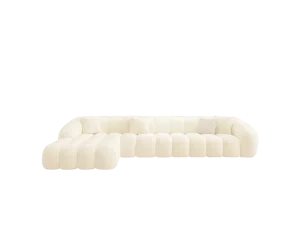 Cream tufted L-shaped sectional sofa with decorative pillows and an ottoman, arranged in a cozy living space.