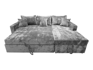 UrbanCloud L-Shaped Sofa Grey velvet with pillows and a footrest, featuring a pull-out bed for added functionality.
