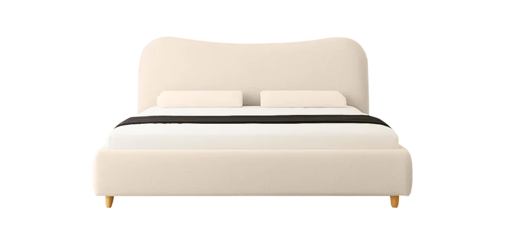 A white the ashley bed with a black headboard, featuring a crisp white duvet and decorative pillows arranged neatly.