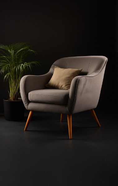 A Grey Chair and a potted plant are positioned in front of a sleek black wall.