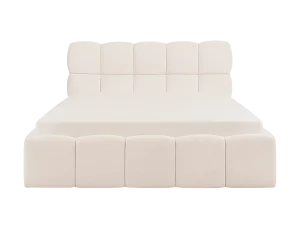 A white bed with a soft light illuminating the bedding, creating a warm and inviting atmosphere.