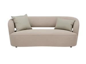 A Fabric Sofa couch adorned with pillows sits in a dimly lit room, creating a cozy and inviting atmosphere.