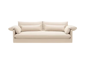 A white couch is positioned in a dimly lit room, creating a striking contrast with the dark surroundings.